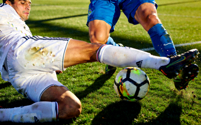 足球运动员在绿茵场上激烈拼抢的瞬间特写